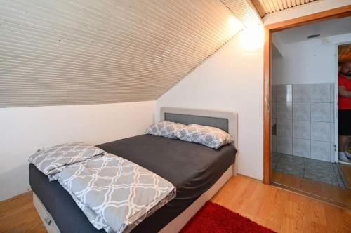 a small bedroom with a bed and a shower at Villa maskara in Bihać