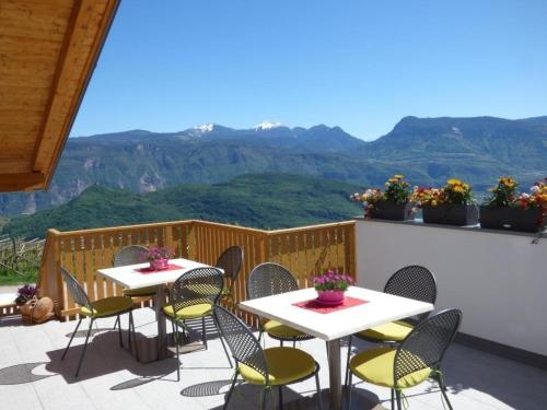 eine Terrasse mit Tischen und Stühlen mit Bergen im Hintergrund in der Unterkunft Appartement in Altenburg mit Terrasse und wunderbarem Ausblick in die Südtiroler Bergwelt in Castelvecchio