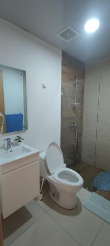 a bathroom with a toilet and a sink and a shower at Boca del Mar Residence, Boca Chica in Boca Chica