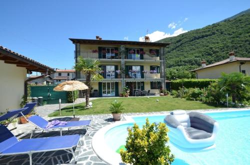 a villa with a swimming pool and a resort at Großzügiges Ferienhaus mit hohem Komfort auf Gartengrundstück mit Pool fast direkt am See in Colico