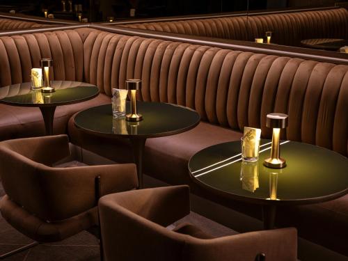 two tables in a restaurant with two chairs at Pulso Hotel Faria Lima in Sao Paulo