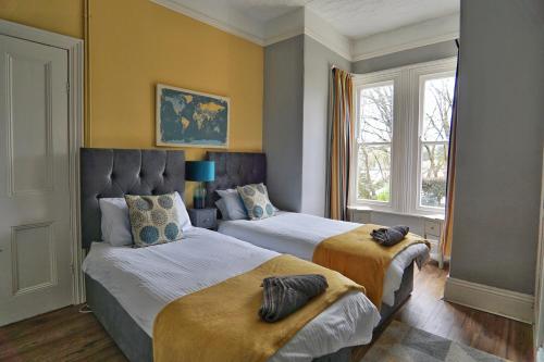 a bedroom with two beds and a window at Roselyn House in Par