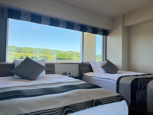 Säng eller sängar i ett rum på Condominium Hotel Okinawa Yumeto - Vacation STAY 17407v