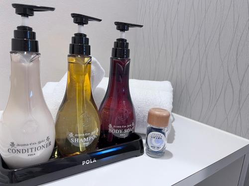 a group of three bottles sitting on top of a counter at Condominium Hotel Okinawa Yumeto - Vacation STAY 16578v in Nanjo