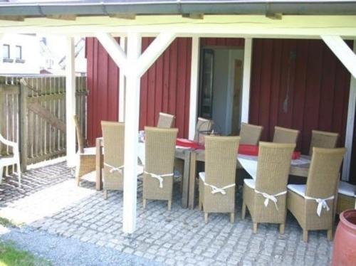 a wooden table and chairs on a patio at Haus Hermann in Presseck