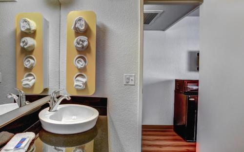 a bathroom with a white sink and a sink at Motel 6-Medford, OR in Medford