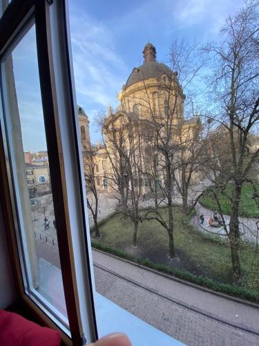 a view of a building from a window at Museum Apartments in Lviv