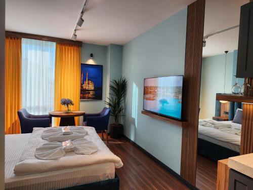 a hotel room with two beds and a flat screen tv at Dream house 22 in Istanbul