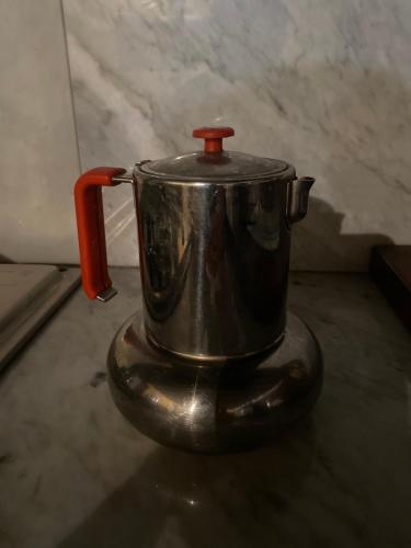 a metal pot sitting on top of a stove at VICOLOVOLTA16 in Torri del Benaco