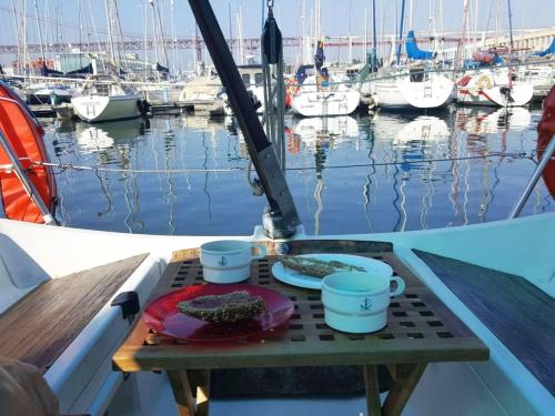 una mesa en la parte trasera de un barco con parrilla en Be Local - Sleep aboard the Santa Maria sailing boat in Lisbon, en Lisboa