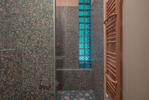 a bathroom with a shower with a glass door at Resume Apartments, Swimmer Corner No 2 by URBAN RENT in Kaunas