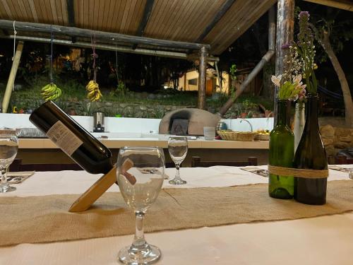 a table with a bottle of wine and two glasses at Terra Encantada in Maranura