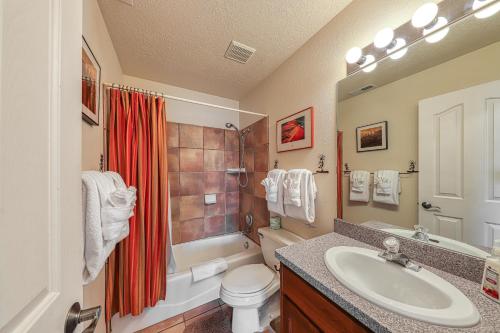 a bathroom with a sink and a toilet and a shower at Rim Village L3 in Moab