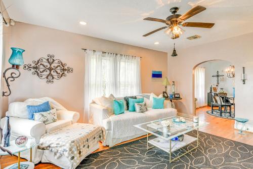 a living room with a white couch and a ceiling fan at Pet-Friendly Galveston Bungalow, half Mi to Beach! in Galveston