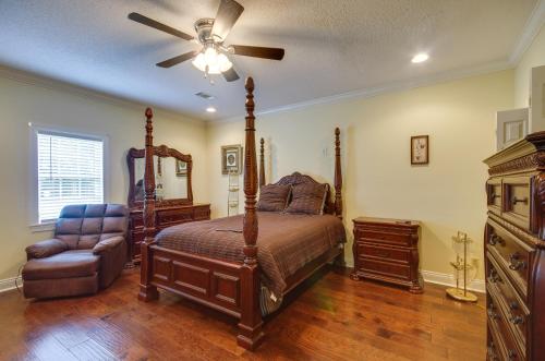ein Schlafzimmer mit einem Bett, einem Ventilator und einem Stuhl in der Unterkunft Homey Greenwood Getaway with Patio and Backyard in Greenwood