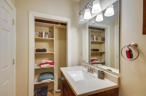 a bathroom with a sink and a mirror at Homey Greenwood Getaway with Patio and Backyard in Greenwood