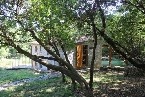 una piccola casa in un cortile alberato di Ferienhaus in Ameglia mit Garten, gemeinsamem Pool und Grill a Monte Marcello
