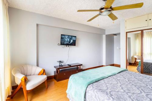 a bedroom with a bed and a ceiling fan at Oceanfront Miraflores Larcomar next to Marriott in Lima