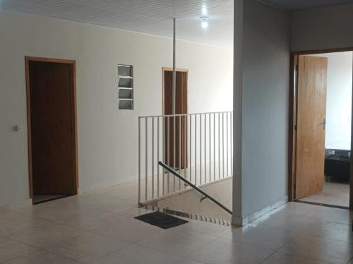 a hallway with a staircase in a building with a door at HOTEL CENTRAL in Chapadão do Céu