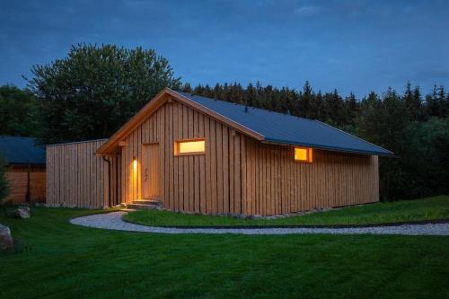 a wooden building with a gambrel roof at Luxuschalet im FORSTGUT - Raum für wertvolle Zeit in Regen