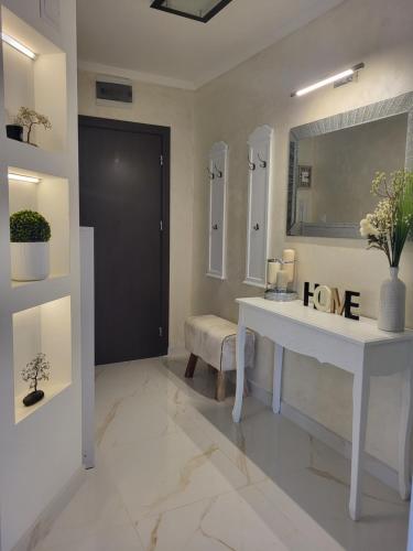 a bathroom with a white sink and a mirror at Luxury apartment in Teteven