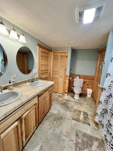 a bathroom with two sinks and a toilet at THE RIVER HOUSE LIMIT 6 home in Hiram