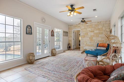 a living room with a couch and a ceiling fan at Modern Farmhouse with Private Pool in Dripping Springs