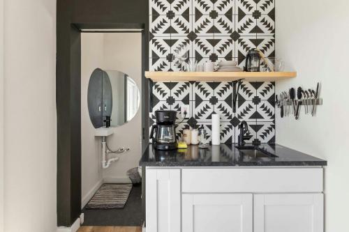 a kitchen with a black and white patterned wall at Hill Country Norwood Estate in Dripping Springs