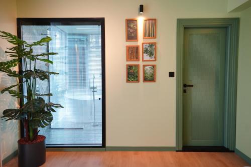 a hallway with a door and a potted plant at Dream house 22 in Istanbul