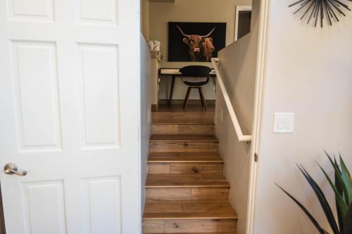 a hallway with a staircase with wood floors at ULTIMATE Mountain Escape with Pool & Hot Tub & Firepit in Sedona