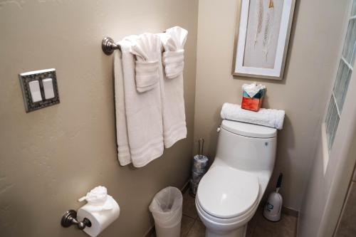 a bathroom with a toilet and towels on the wall at ULTIMATE Mountain Escape with Pool & Hot Tub & Firepit in Sedona
