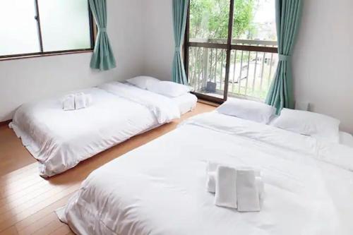 A bed or beds in a room at Itsukaichi First Villa Hiroshima - Vacation STAY 15653