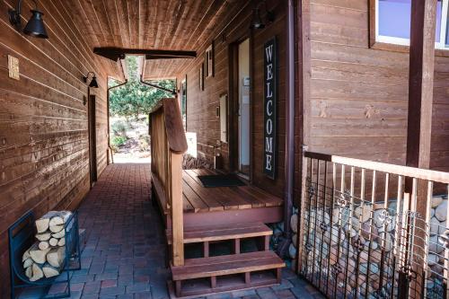 a porch of a wooden house with a wooden staircase at ULTIMATE Mountain Escape with Pool & Hot Tub & Firepit in Sedona
