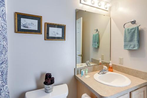 a bathroom with a sink and a toilet and a mirror at Welcoming Port Clinton Home with Private Deck! in Port Clinton