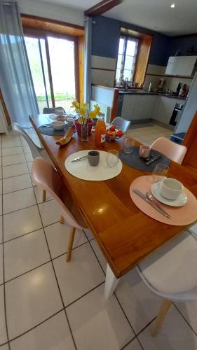 a wooden table in a kitchen with a dining room at Sur les Rives du Haut Allier in Blassac