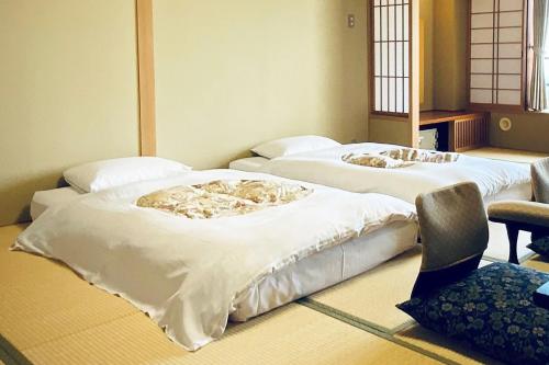 two beds sitting in a room at Hotel Taiko - Vacation STAY 21755v in Myoko