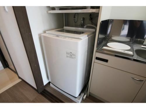 a small refrigerator in a kitchen with a sink at Sakuraya - Vacation STAY 14453v in Takahara