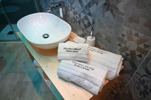 a bathroom with a sink and towels on a counter at DUCA DEGLI ABRUZZI Modern House LUXURY RELAX in Brindisi