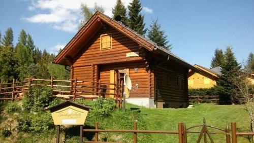 a log cabin with a sign in front of it at Ferienhaus Stoakoglhütte in Klippitztörl in Klippitztorl