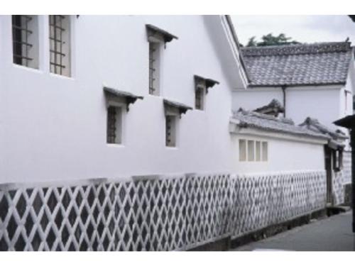 a black and white photo of a white building at Senshunraku - Vacation STAY 18475v in Hagi