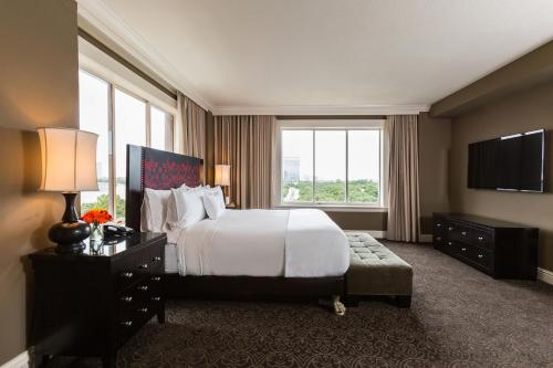 a hotel room with a bed and a large window at Hotel Zaza Houston Museum District in Houston