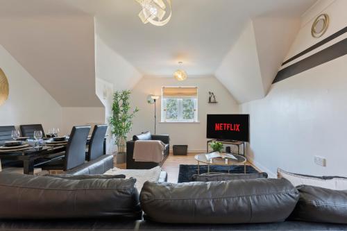 a living room with a leather couch and chairs at City Gate in Birmingham