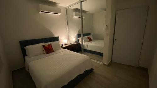 a hotel room with a bed and a mirror at Casa Orillia's Del Mar in Isabela