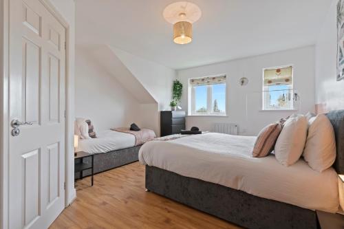 a bedroom with two beds and a door at City Gate in Birmingham