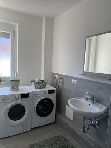 a washing machine in a bathroom with a sink at Stadtvilla in Hechingen in Hechingen