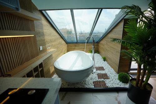 a bathroom with a bath tub in a room with windows at Dream house 22 in Istanbul