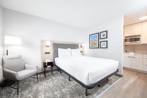 a hotel room with a bed and a chair at The Jackson SouthTown in Jackson