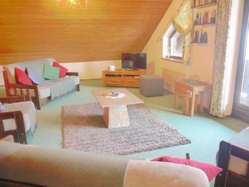 a living room with a couch and a table at Wohl eingerichtete Wohnung mit eigenem Balkon und Panoramablick in Sankt Michael im Lungau