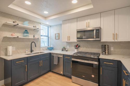 a kitchen with blue cabinets and stainless steel appliances at Luxury Retreat with Private Pool & Workspace - N268 in Scottsdale