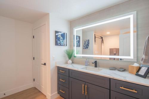 a bathroom with a sink and a large mirror at Exclusive-Walk to Golf, Shopping & Dining-King Bed N268 in Scottsdale